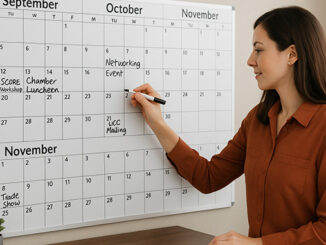 Factoring Broker using a dry-erase wall calendar to track upcoming events