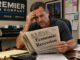 Business owner reading about a recession.